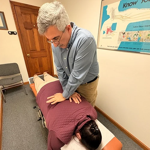 Chiropractor David Harnois Adjusting Patient